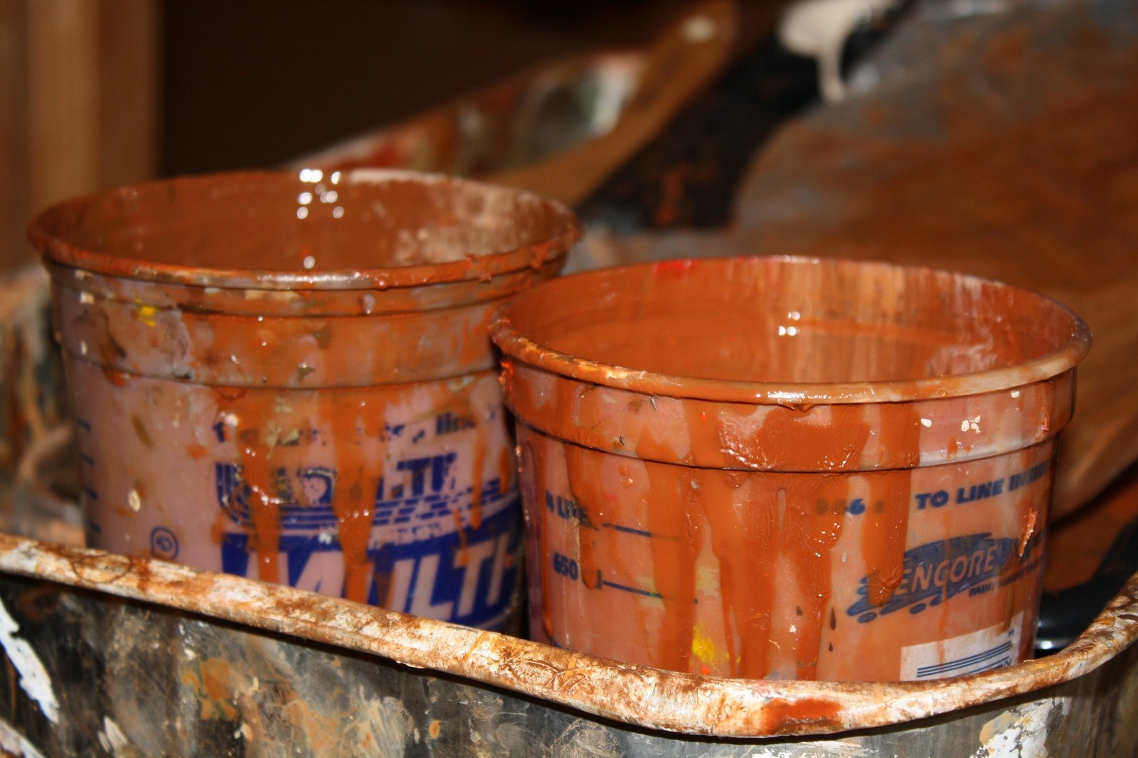 Close up of paint cups in burnt sienna