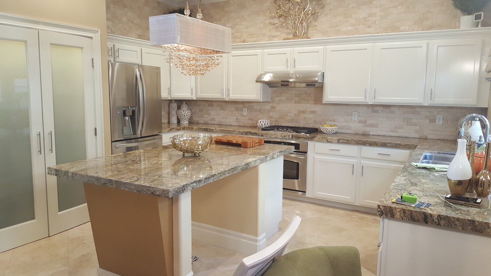 Refinished kitchen cabinetry from brown wood to white lacquer